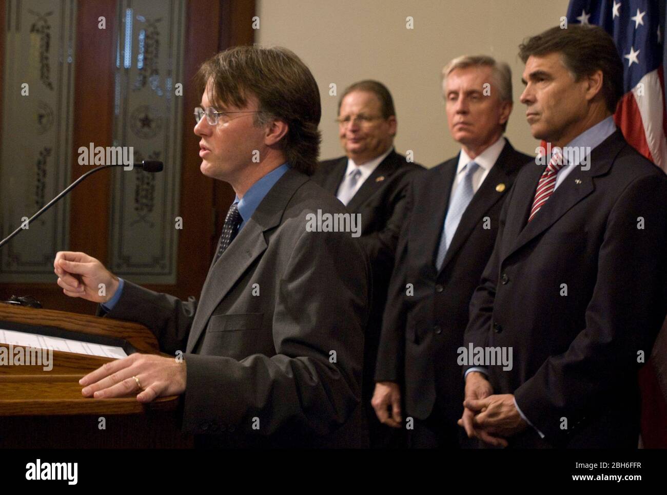 Austin, Texas USA, April 29th, 2009: Dr. David Lakey, Commissioner of the Texas Department of State Health Services, speaks at a press conference o discuss the state's efforts in response to the swine flu. Gov. Rick Perry stands behind Lakey and state education commissioner Robert Scott stands on the right. ©Marjorie Kamys Cotera/Daemmrich Photography Stock Photo