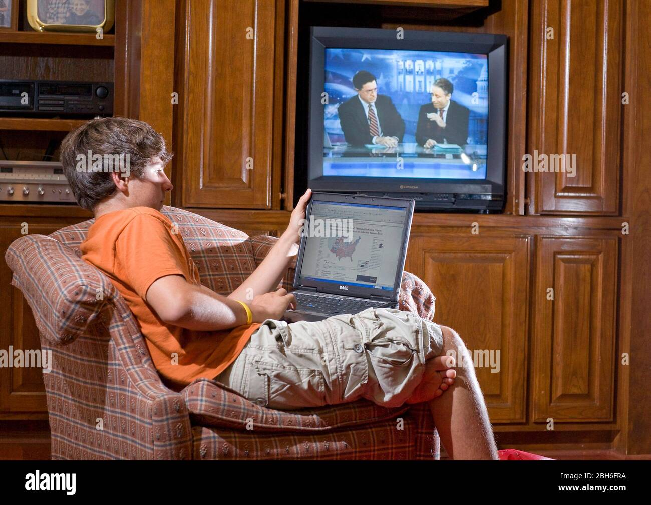 Austin, Texas USA, November 4, 2008: High School student (14) monitors election results on election night on the Internet and television with Stephen Colbert (l) and Jon Stewart (r) during the historic win for Barack Obama as President of the United States.   ©Bob Daemmrich Stock Photo
