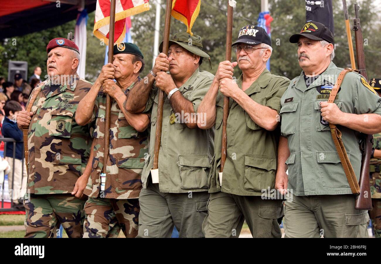 Laredo, Texas USA, February 20, 2009. 112th-annual  festival parade celebrating the birthday of the first President of the United States, George Washington, in downtown Laredo. Laredo Vietnam veterans carrying flags and rifles march in the parade past the review stand.  ©Bob Daemmrich Stock Photo