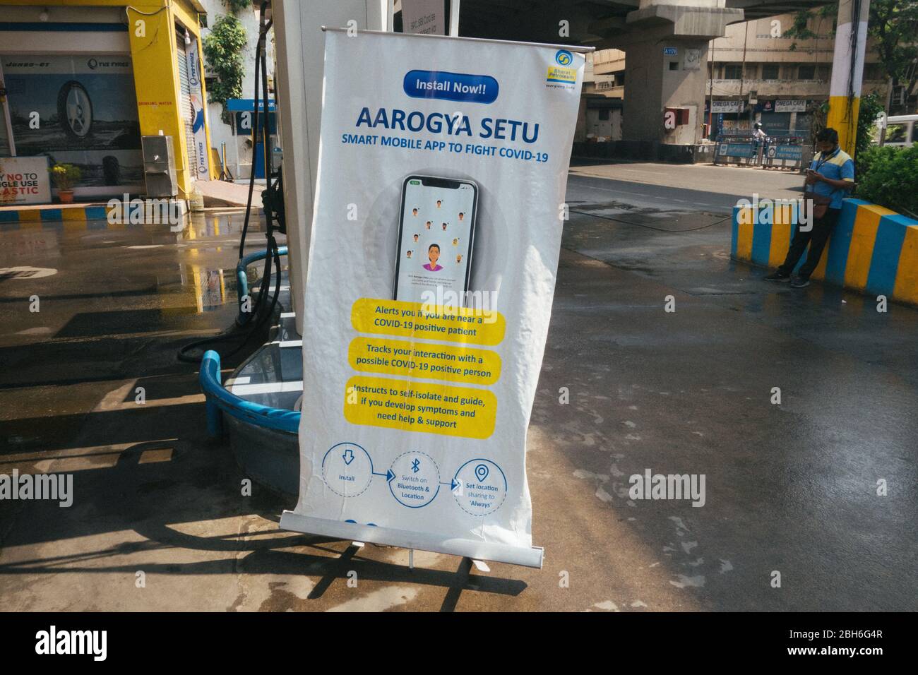 Hyderabad, India. 24th April, 2020.A banner of Aarogya setu stands at a gas station during covid 19 pandemic lockdown in Hyderabad,India.Aarogya Setu is a mobile application developed by the Government of India to connect essential health services with the people of India to fight against COVID-19.. Credit:Sanjay Borra/Alamy News Stock Photo