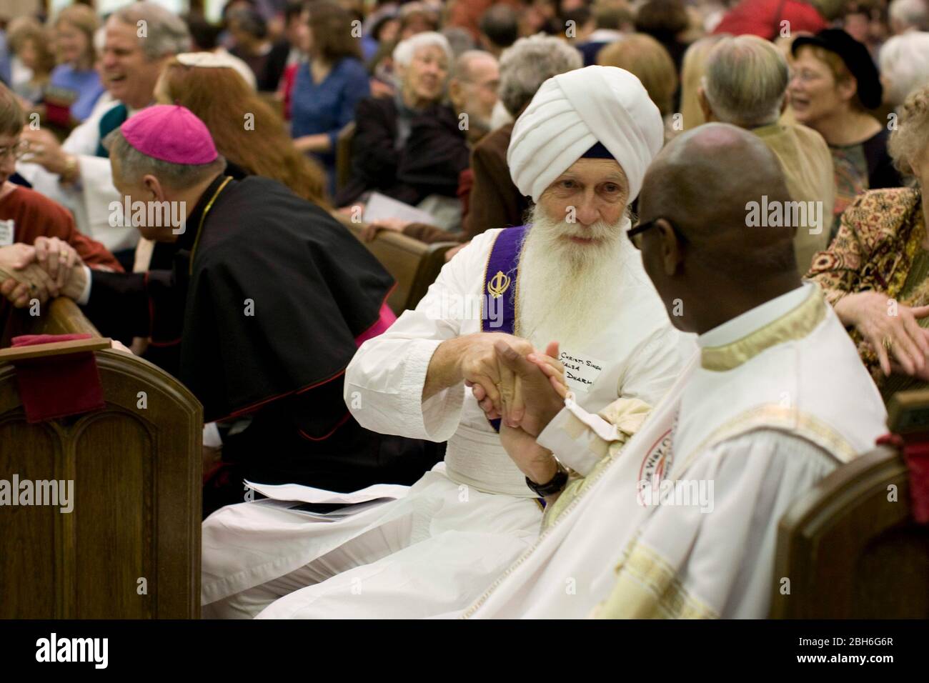 Austin, Texas: November 23, 2008. Austin Area Interreligious Ministries' (AAIM) 24th annual Interfaith Thanksgiving celebration of diversity  showing a Sikh priest shaking hands with a Baptist minister at the service.  ©Bob Daemmrich Stock Photo