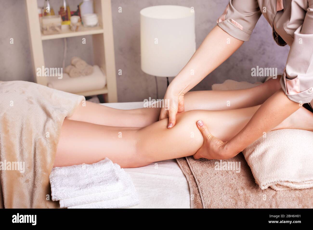 Woman having sports foot massage. rejuvenating foot massage for athletes in Spa Salon Stock Photo