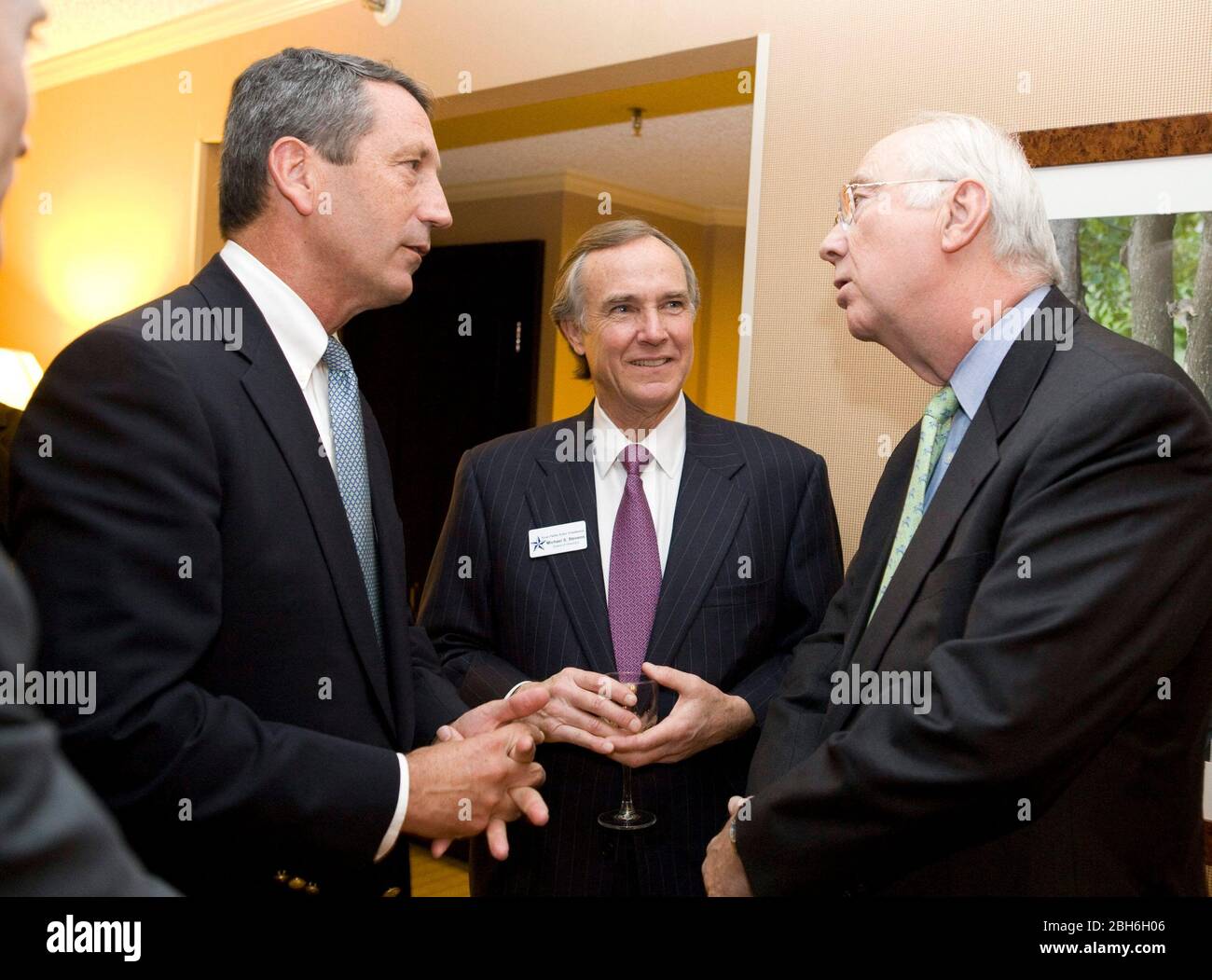 Austin, TX January 10, 2008: Conservative South Carolina Governor Mark Sanford (l) at the Texas Public Policy Foundation dinner speaking with conservative former Sen. Phil Gramm (r), Both have been mentioned as a possible Vice-Presidential picks for 2008.  At center is lobbyist Michael Stevens.    ©Bob Daemmrich Stock Photo