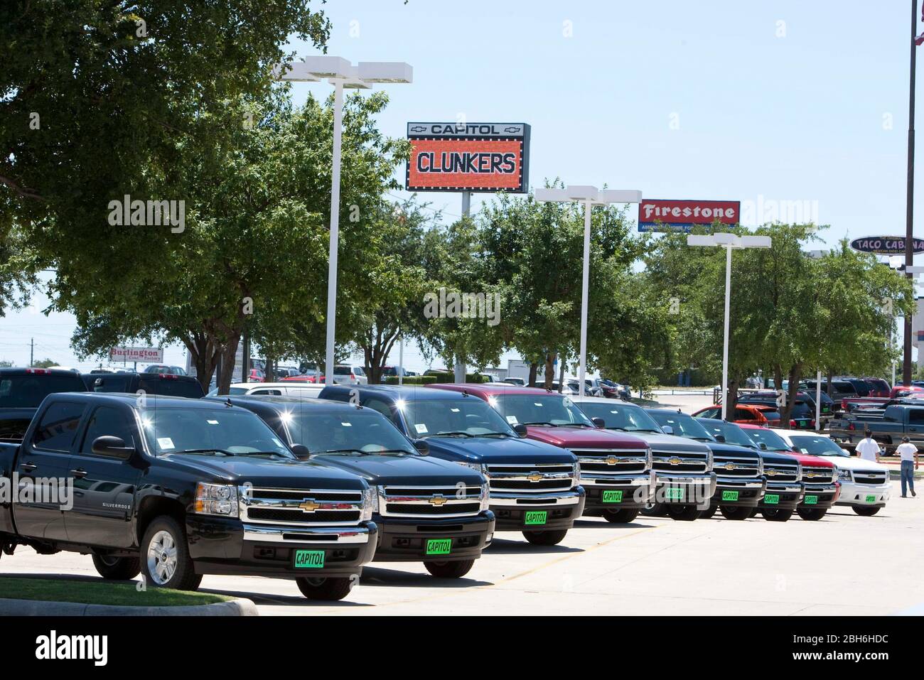Austin, TX August 7, 2009:  New cars are displayed below a sign touting the Cash for Clunkers program at Capitol Chevrolet in Austin, awaiting disposal after the deals are finished.  Dealers are waiting on their checks from the government before proceeding with disposal.   ©Bob Daemmrich Stock Photo