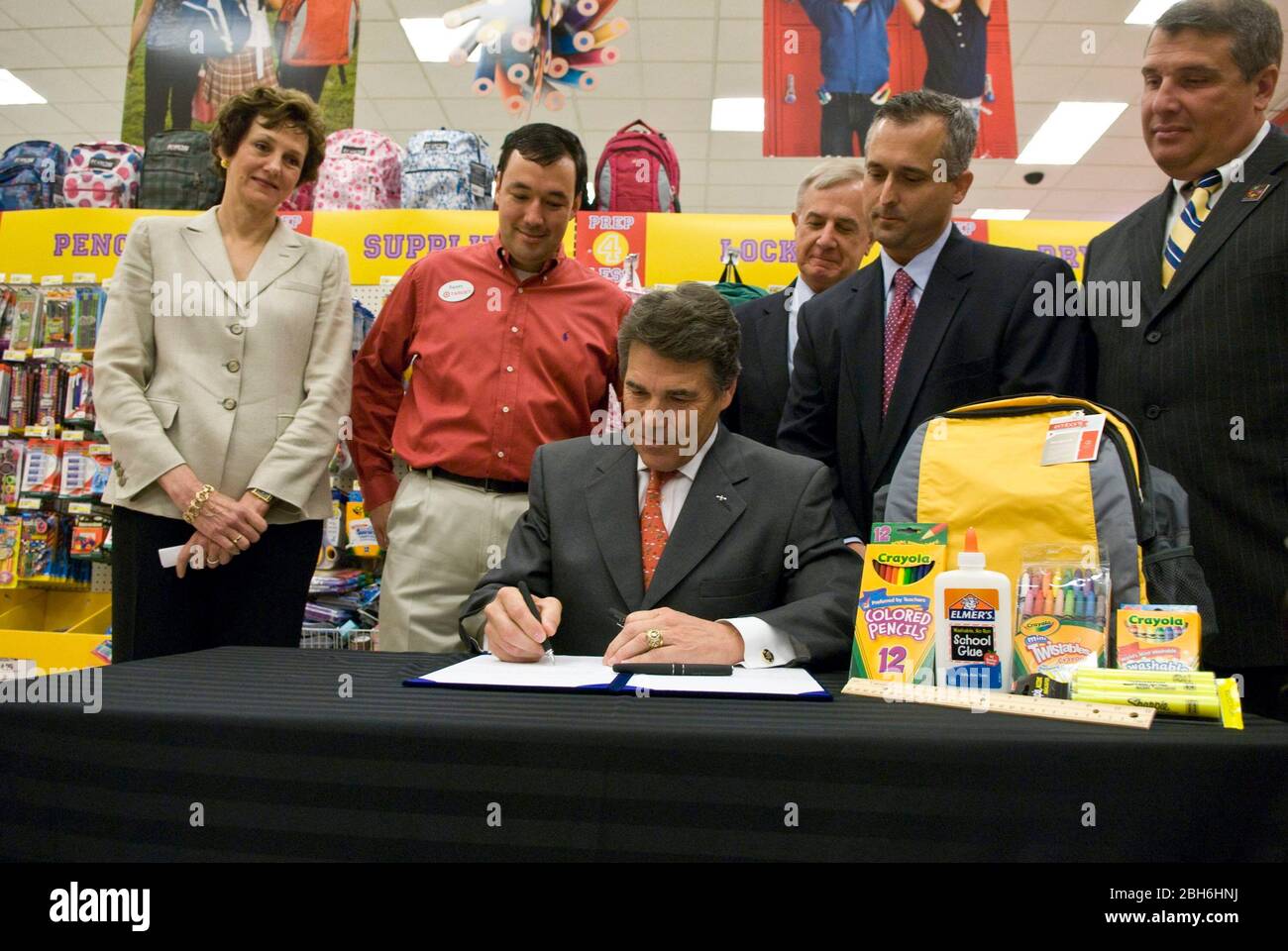 Austin, Texas USA, August 20, 2009. Texas Gov. Rick Perry signs House Bill 1801, which adds school supplies to the list of items exempt from state sales tax during the annual sales tax holiday, at a Target retail store. Texas Comptroller Susan Combs stands on far left. ©Marjorie Kamys Cotera/Daemmrich Photography Stock Photo