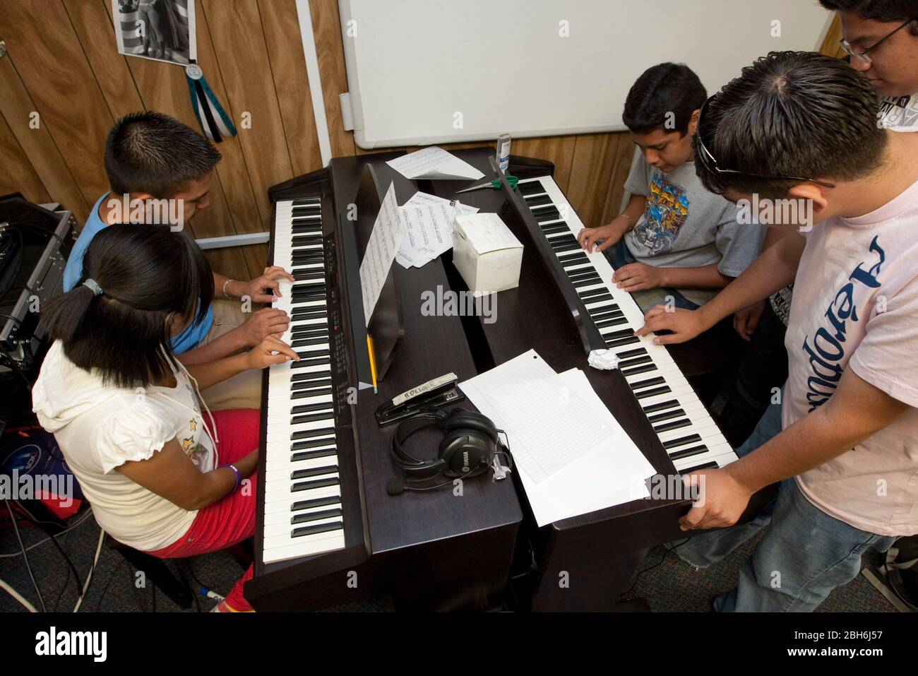 El Paso, Texas May 28, 2009: High school students learn piano keyboard in a  music appreciation class at Mission Early College High School. Motivated  students can earn an associate degree at El