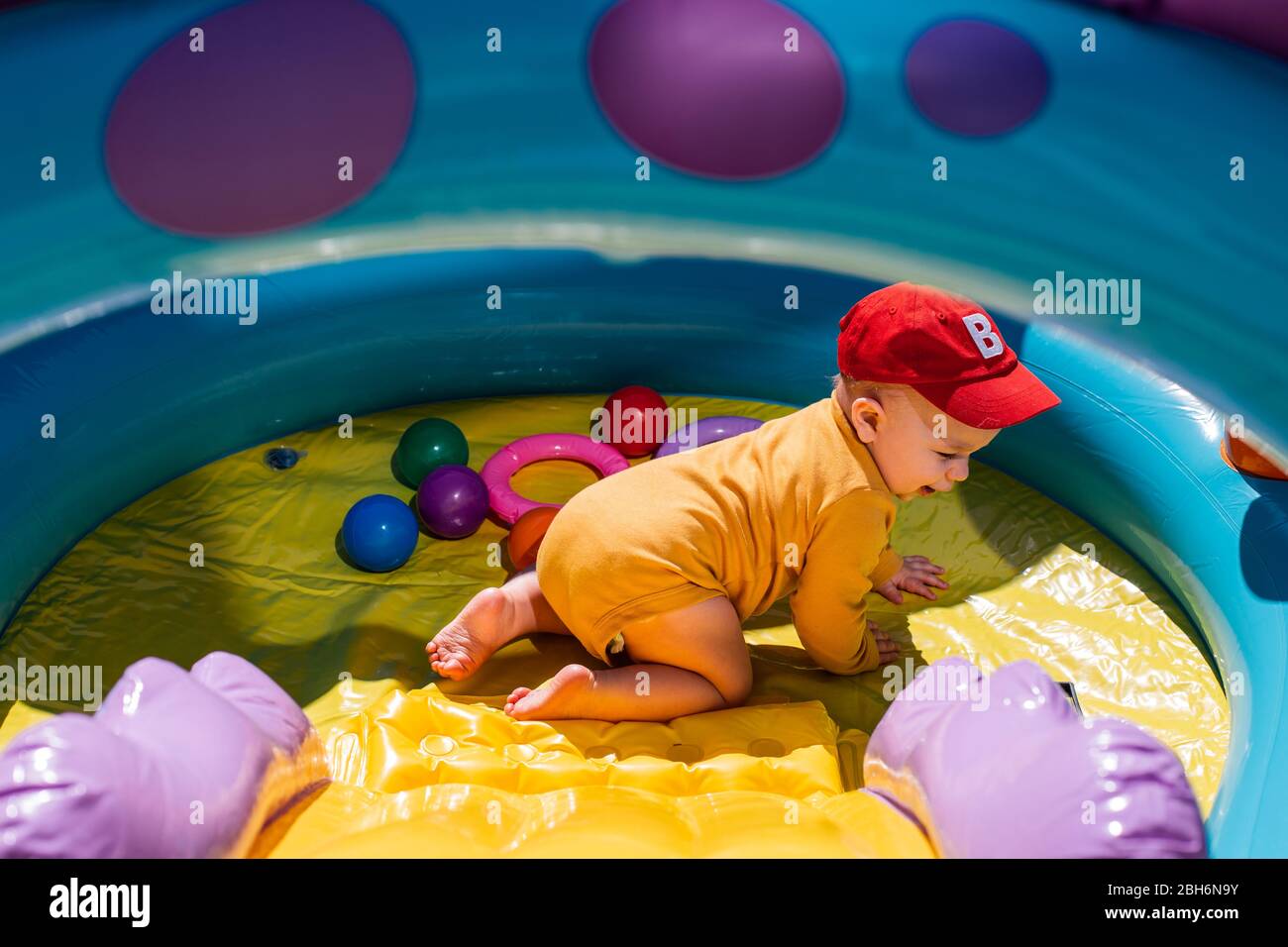 Baby playing in paddling pool Stock Photo Alamy