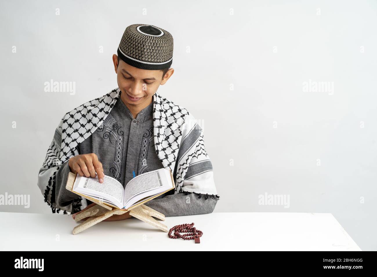muslim male reading quran over white background. ramadan kareem Stock Photo