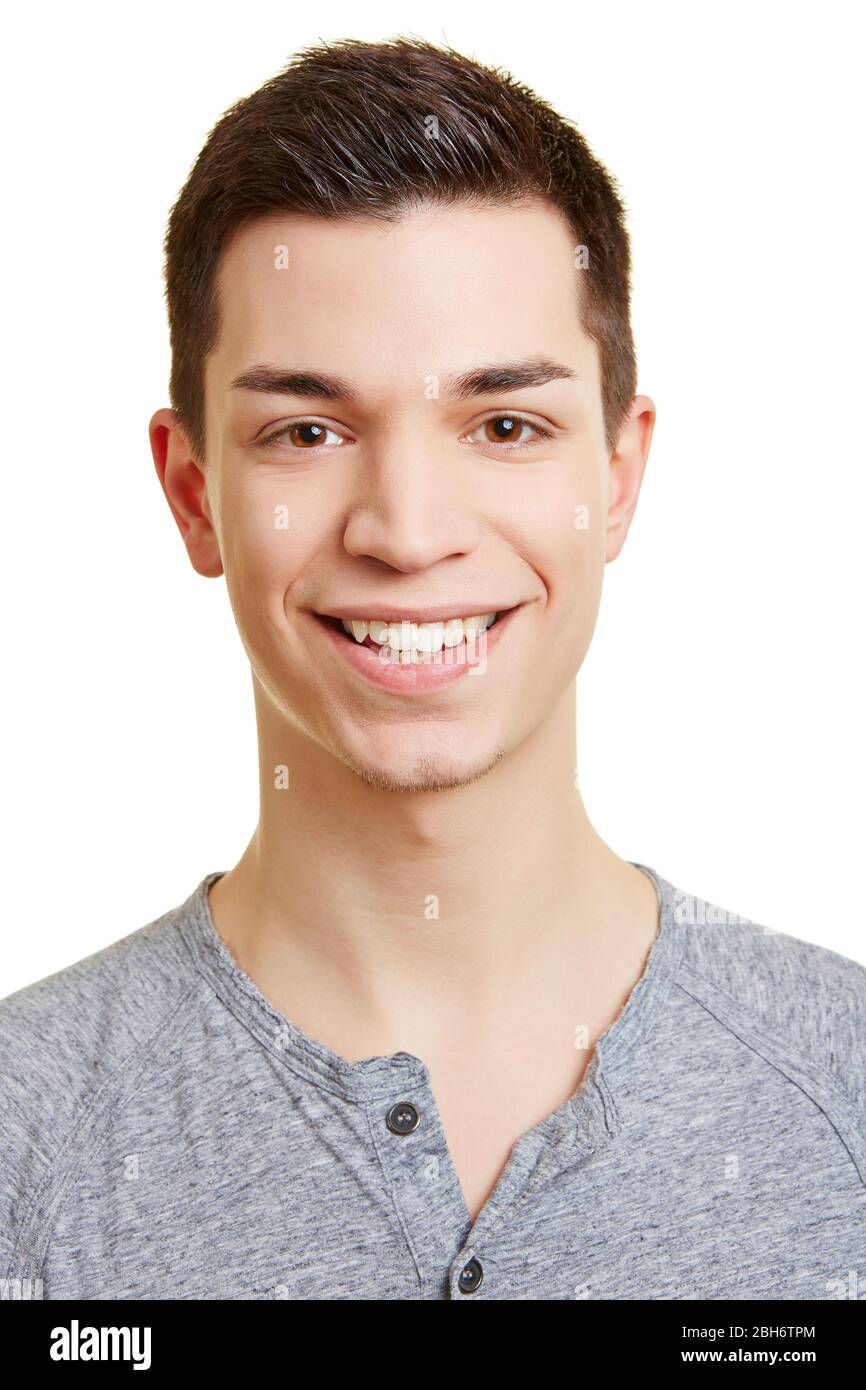 Laughing young man happily looks at the camera Stock Photo