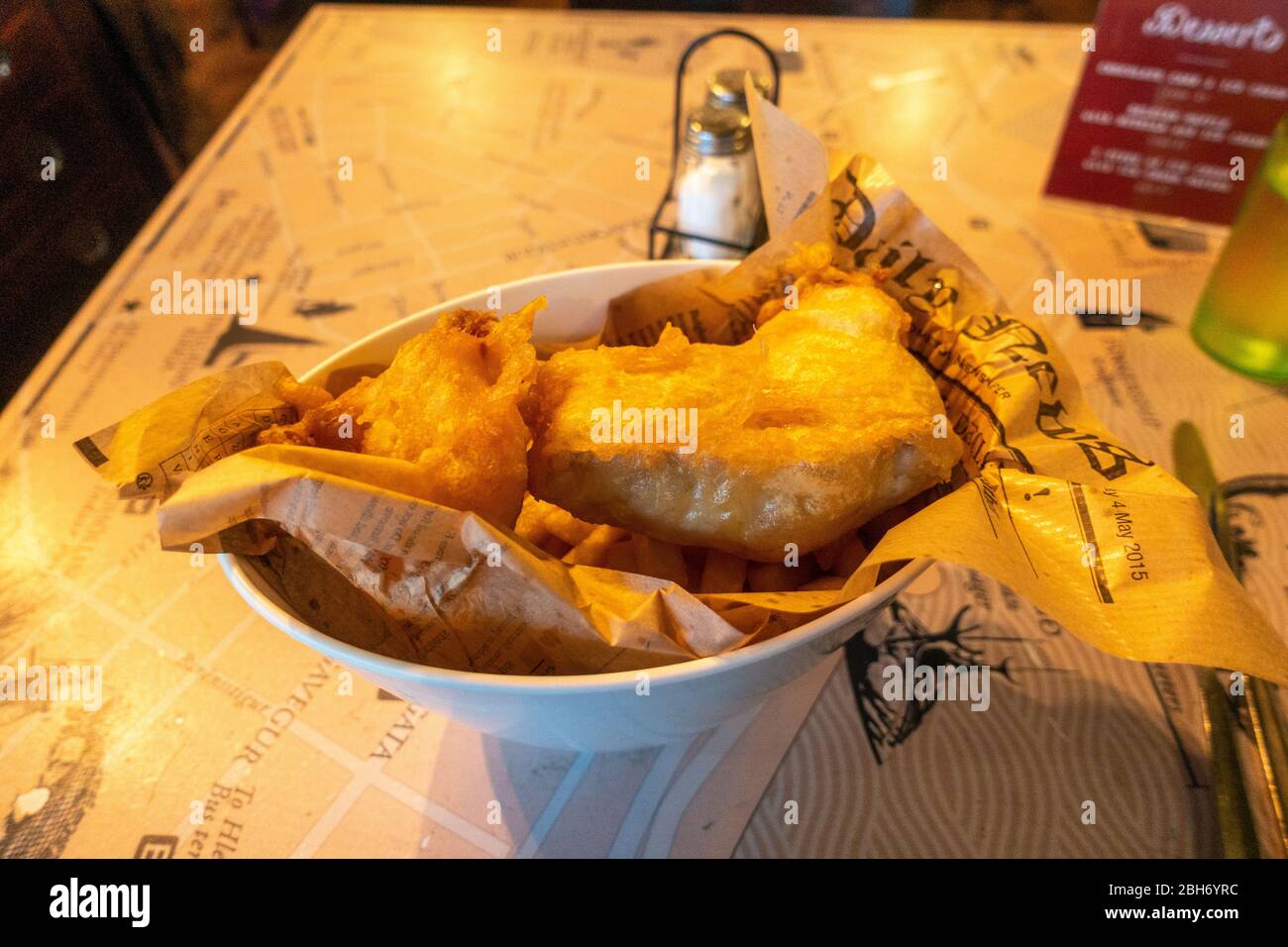 A bowl of fish and chips (cod) on a restaurant table (in the Reykjavik Fish Restaurant) in Reykjavik, Iceland. Stock Photo