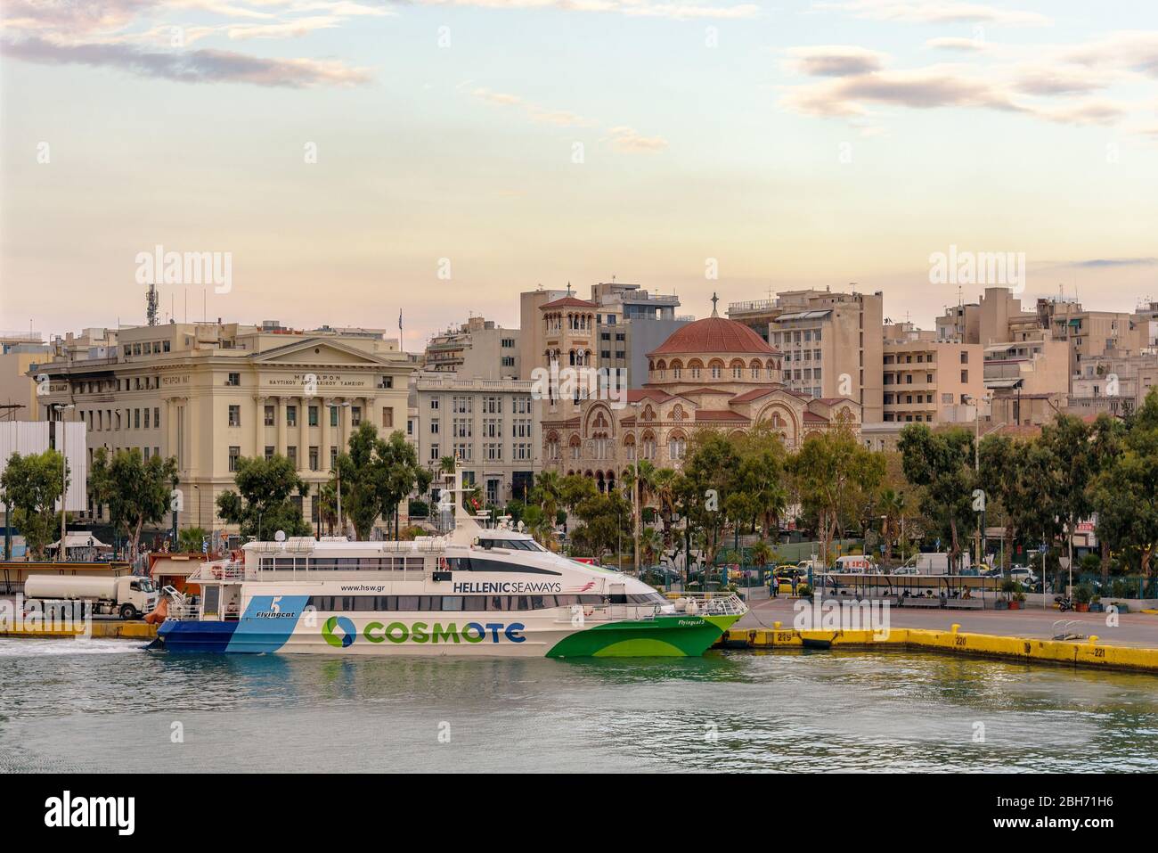 A Hellenic Seaways ferry docked in the Port of Piraeus with the Holy Trinity church visible Stock Photo