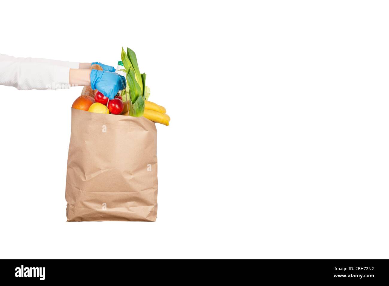 Safe food delivery or donation concept. Food delivery during coronavirus quarantine. Paper bag with different food ingredients such as fruits, vegetab Stock Photo