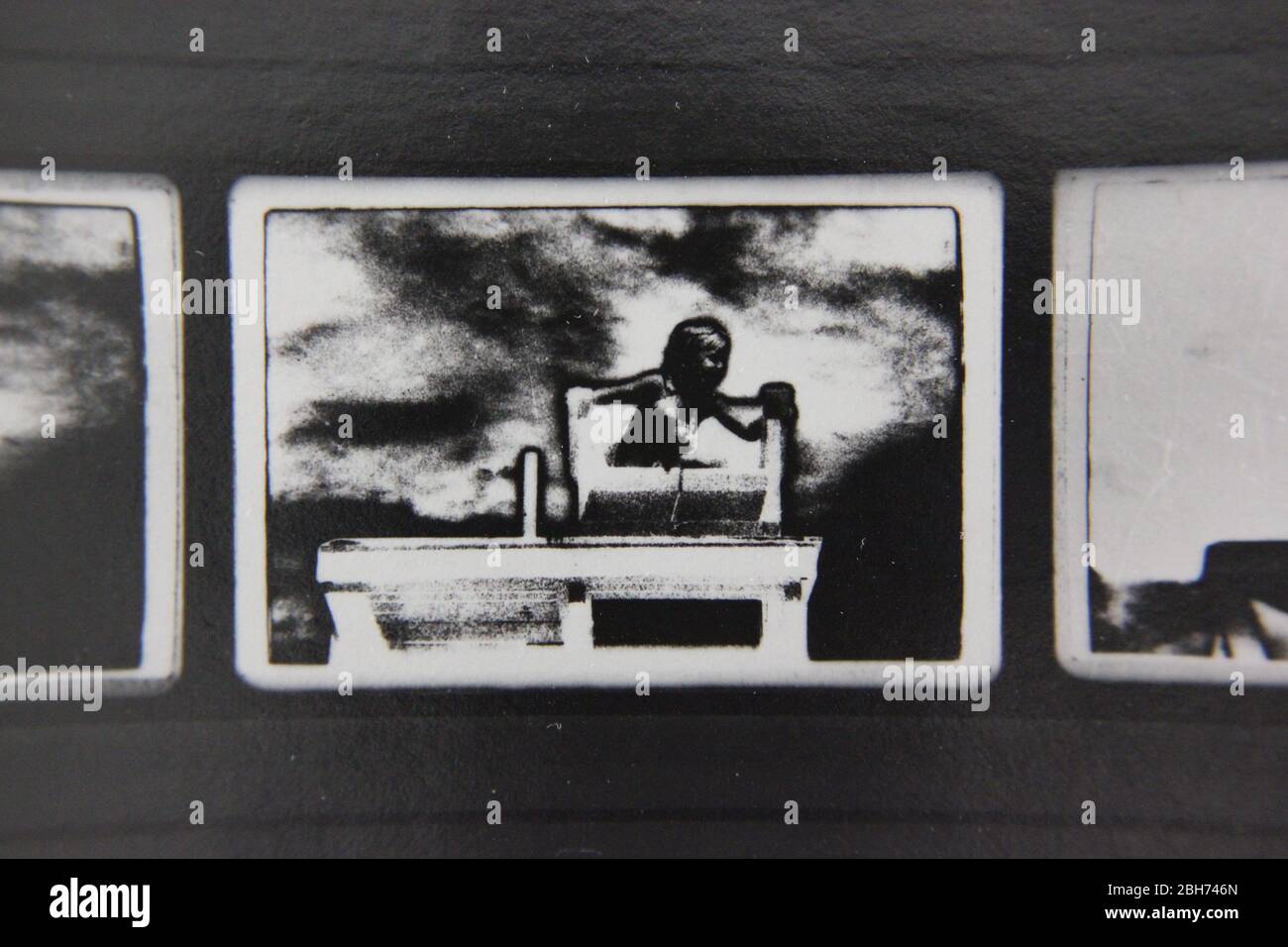 Fine 70s vintage extreme high contrast contact print photography of a girl sitting in a lifeguard chair, higher ground Stock Photo