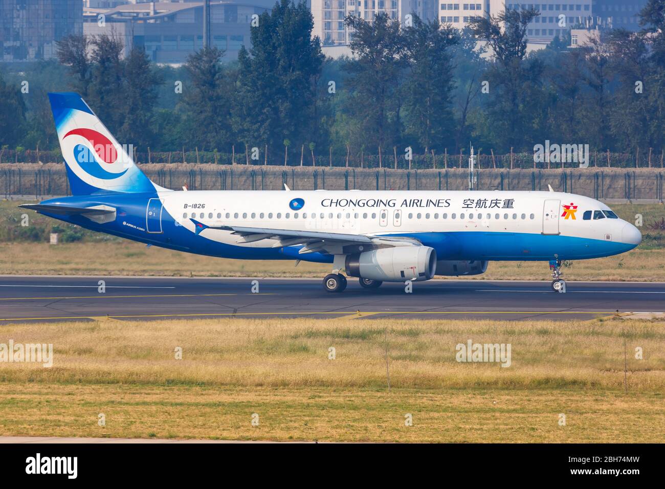 Beijing, China – October 2, 2019: Chongqing Airlines Airbus A320 airplane at Beijing airport (PEK) in China. Stock Photo