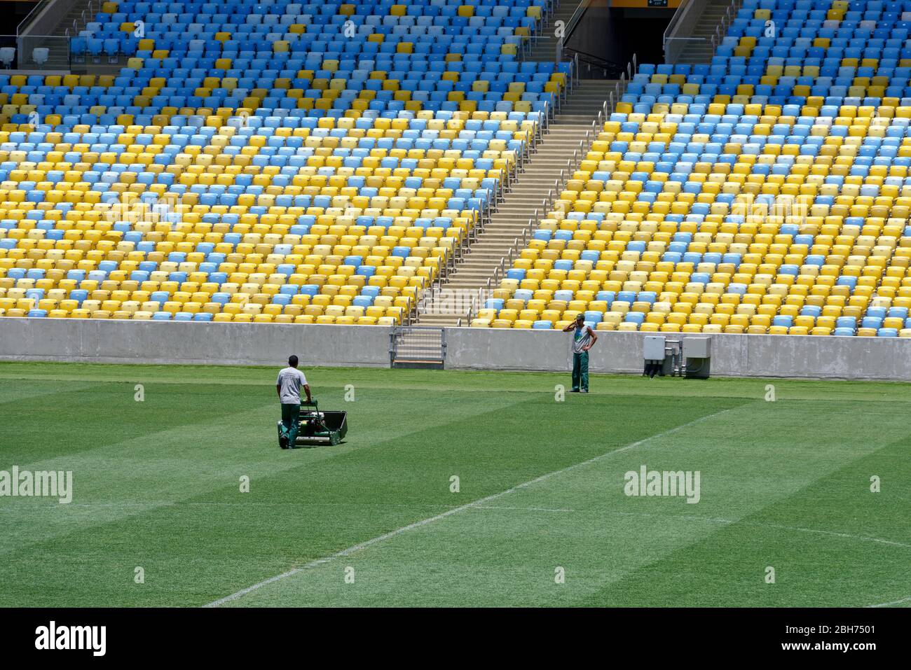 Maracanã stadium groundskeepers trim turf with scissors for NFL game
