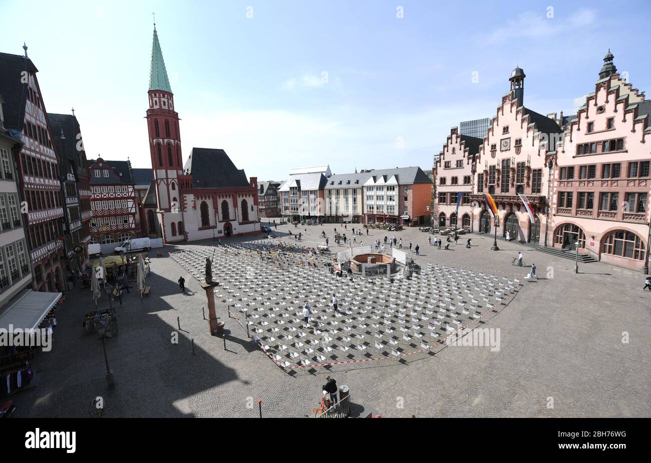 24 April 2020, Hessen, Frankfurt/Main: With empty chairs Frankfurt's restaurateurs demonstrate on the Römerberg. With this action the restaurateurs have drawn attention to the critical situation of restaurants and hotels in the Corona crisis. Empty chairs were placed in central squares in 75 German cities nationwide. According to the initiators, there were almost 1000 on the Römerberg. Photo: Arne Dedert/dpa Stock Photo