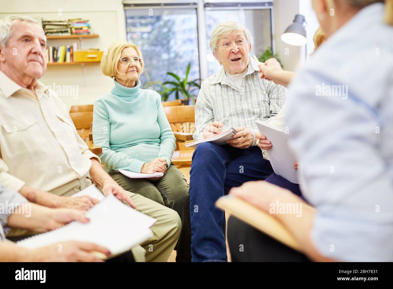 Seniors and therapists in group therapy or group psychotherapy Stock Photo