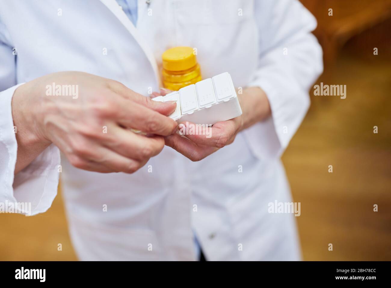 Female doctor with a tablet dispenser and other medication Stock Photo