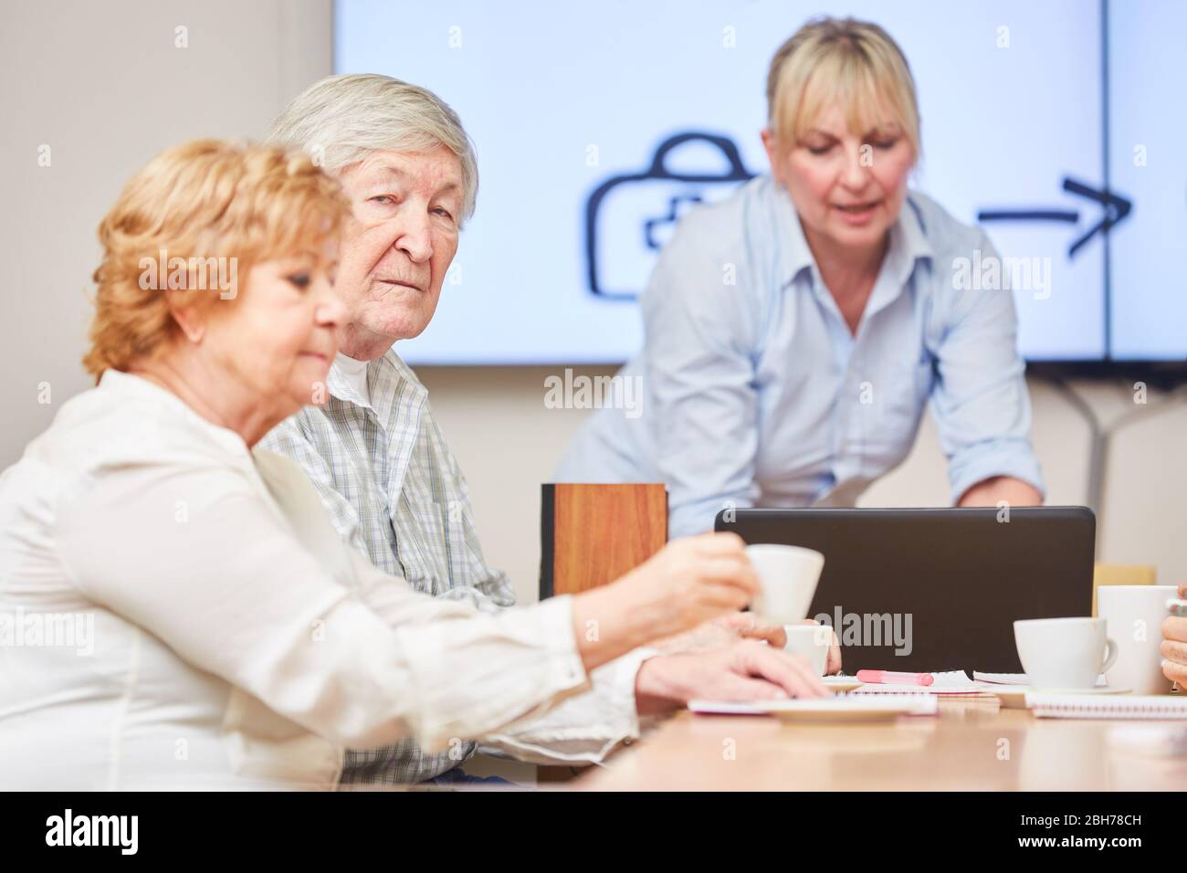 Seniors as retirees in a course or seminar on retirement planning and finance Stock Photo