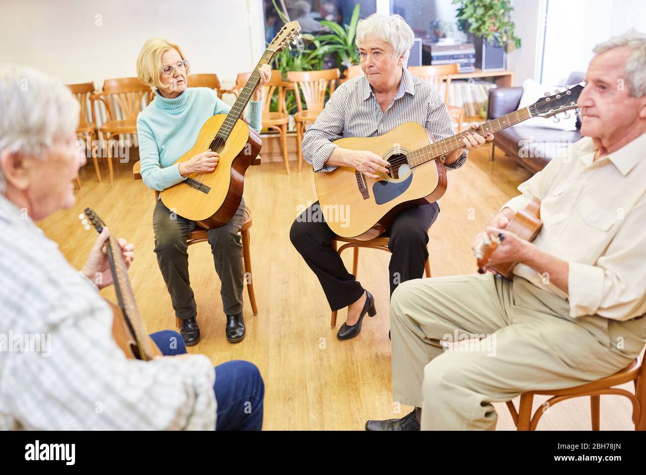 Seniors group takes guitar lessons in a course at the community college