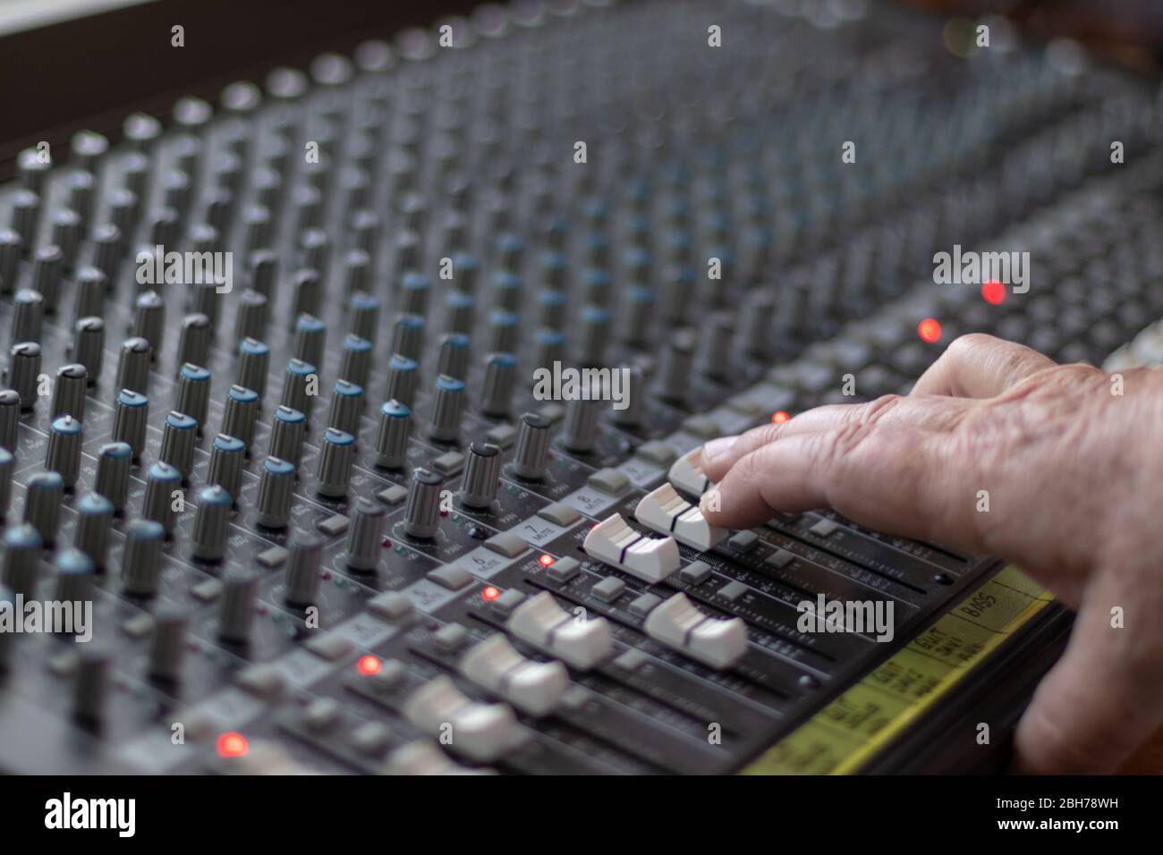 Man's hand handling the sldiers of a professional sound table Stock Photo