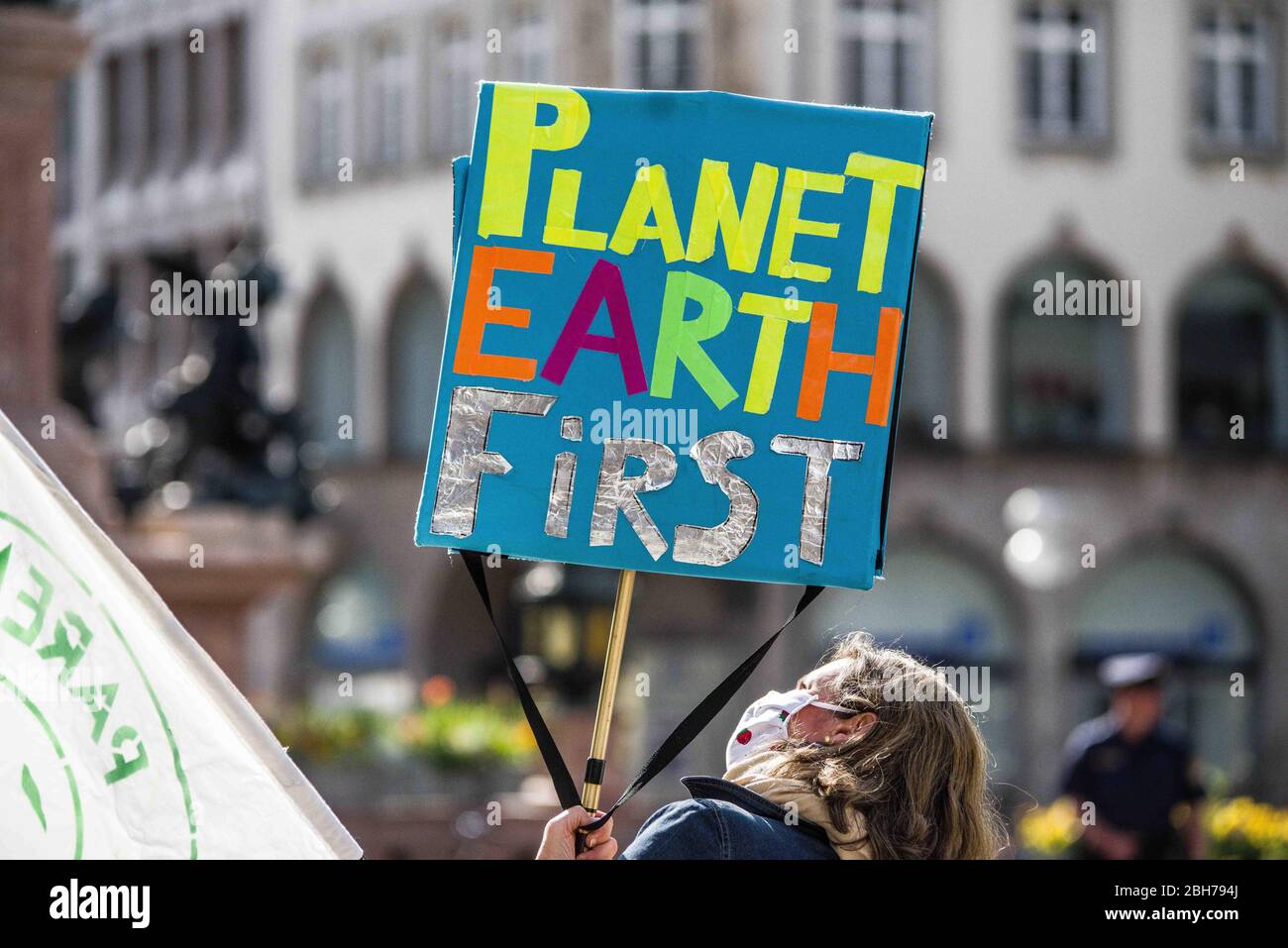 Munich, Bavaria, Germany. 24th Apr, 2020. A demonstrator in Munich, Germany holds a ''planet Earth first'' sign in one of the first demonstrations held during the Coronavirus crisis. Under strict regulations and monitoring by the police for number of participants and distancing, under 20 from Parents for Future demonstrated for the climate at Munich's Marienplatz in Germany, using mottos such as ''climate protection is democratic' Credit: Sachelle Babbar/ZUMA Wire/Alamy Live News Stock Photo