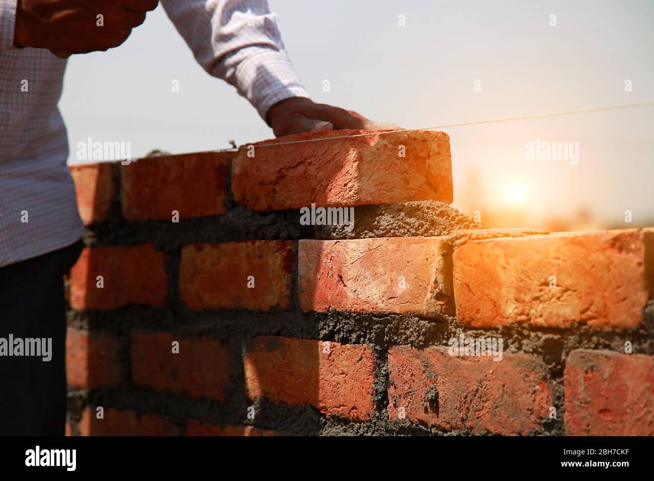 Mason Installing Brick On Construction Site For Making House Stock Photo Alamy