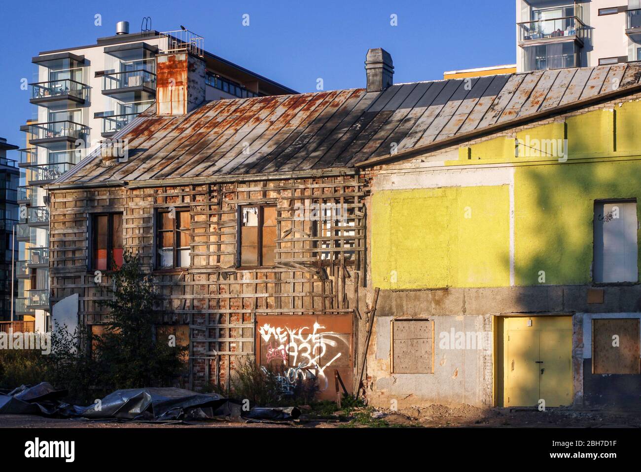 Old dilapidated building in the middle of new residential district in Järvenpää, Finland Stock Photo