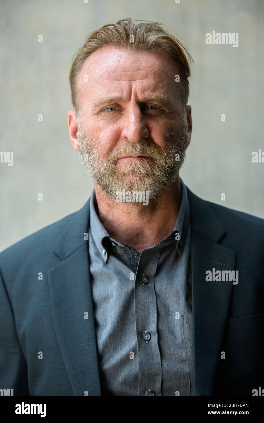 Face of mature handsome bearded businessman wearing suit Stock Photo ...
