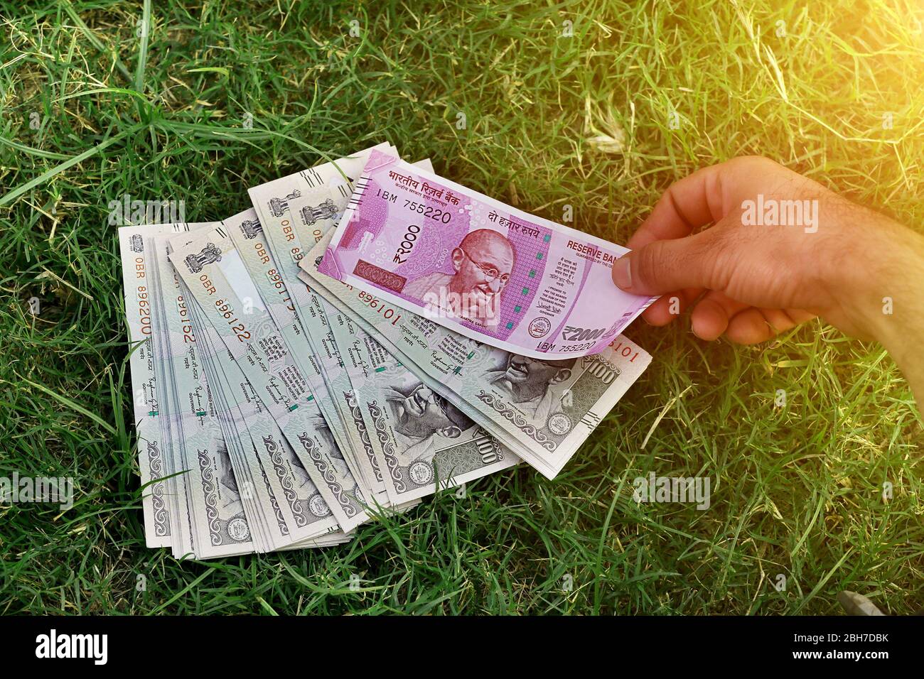 Men holding Indian currency note in hand outdoors in the nature Stock Photo