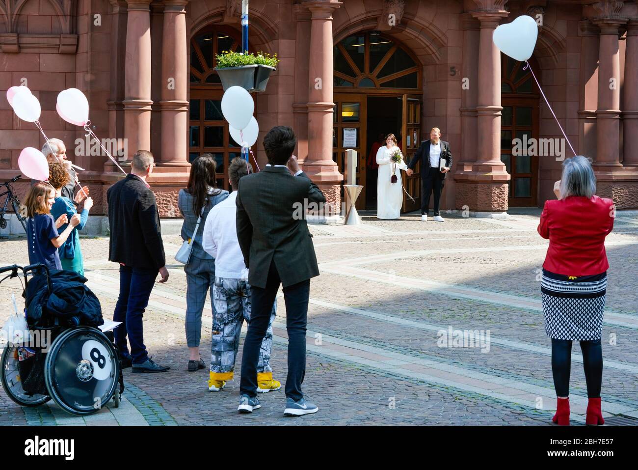 Dortmund, April 24th, 2020: Wedding in Corona times. A couple married on April 24. In front of the registry office, family members and friends congratulated them in the appropriate safety distance. Stock Photo