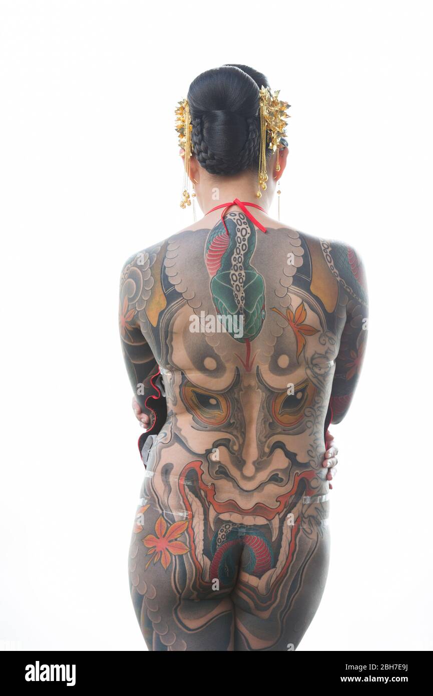 An asian woman with a full body body tattoo, in a japanese style at the 12th London Tattoo Convention 2016, Tobacco Dock, 50 Porters Walk, London, UK. Stock Photo