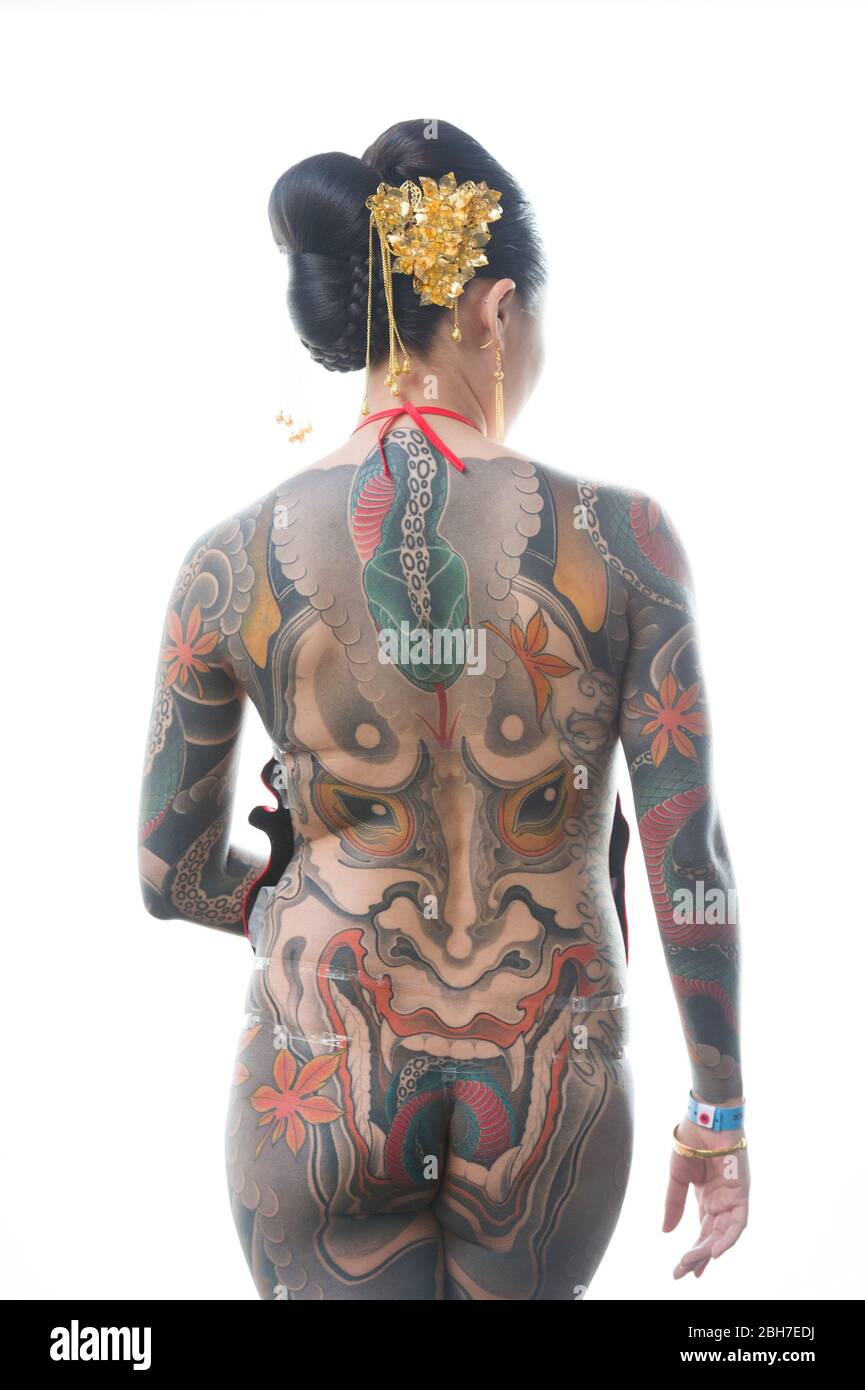 An asian woman with a full body body tattoo, in a japanese style at the 12th London Tattoo Convention 2016, Tobacco Dock, 50 Porters Walk, London, UK. Stock Photo