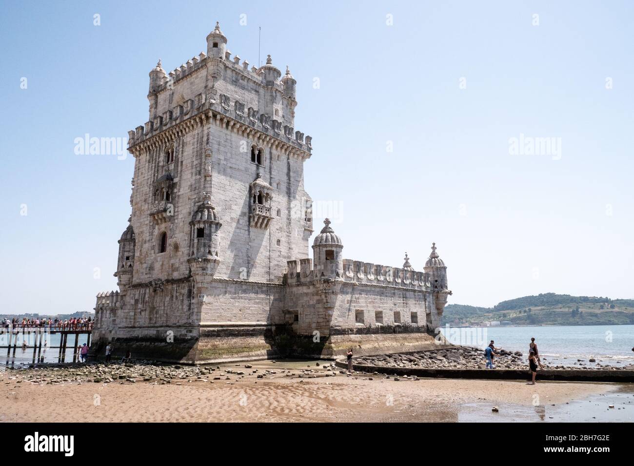 Torre de Belem, Lisboa, Portugal. The popular Lisbon landmark, The Belem Tower on the Tagus River with a line of tourists waiting to enter. Stock Photo
