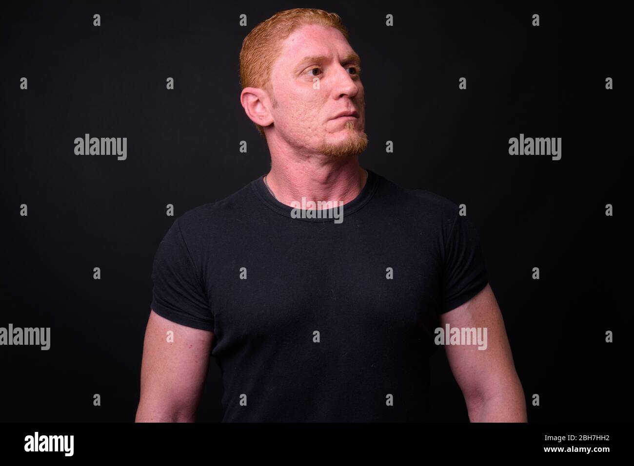 Portrait of muscular man with orange hair thinking Stock Photo