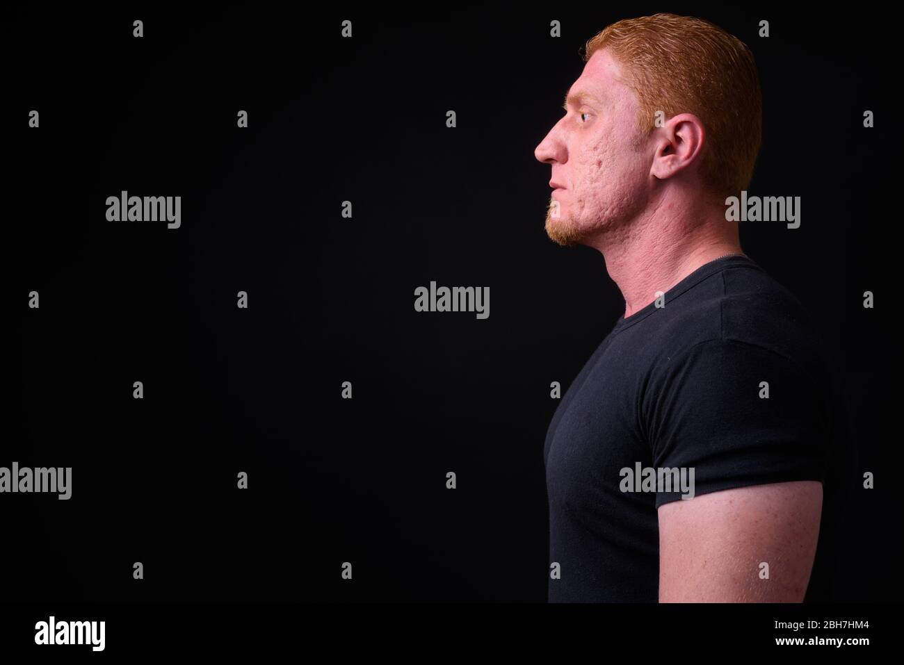 Profile view of muscular man with orange hair Stock Photo