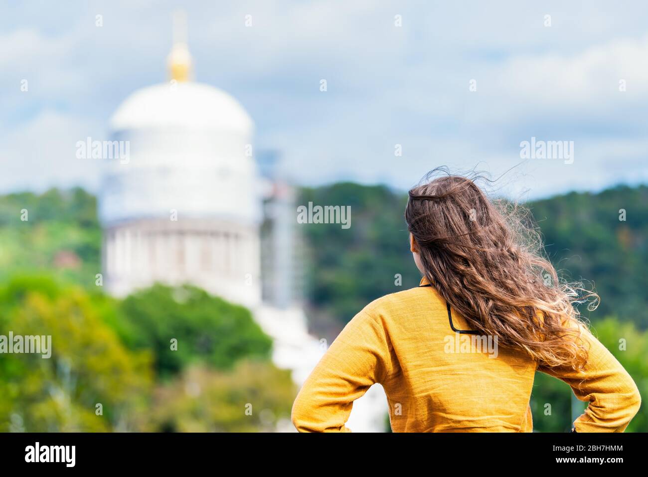 Charleston, West Virginia capital city with back of woman looking at scaffold construction on state capitol dome Stock Photo