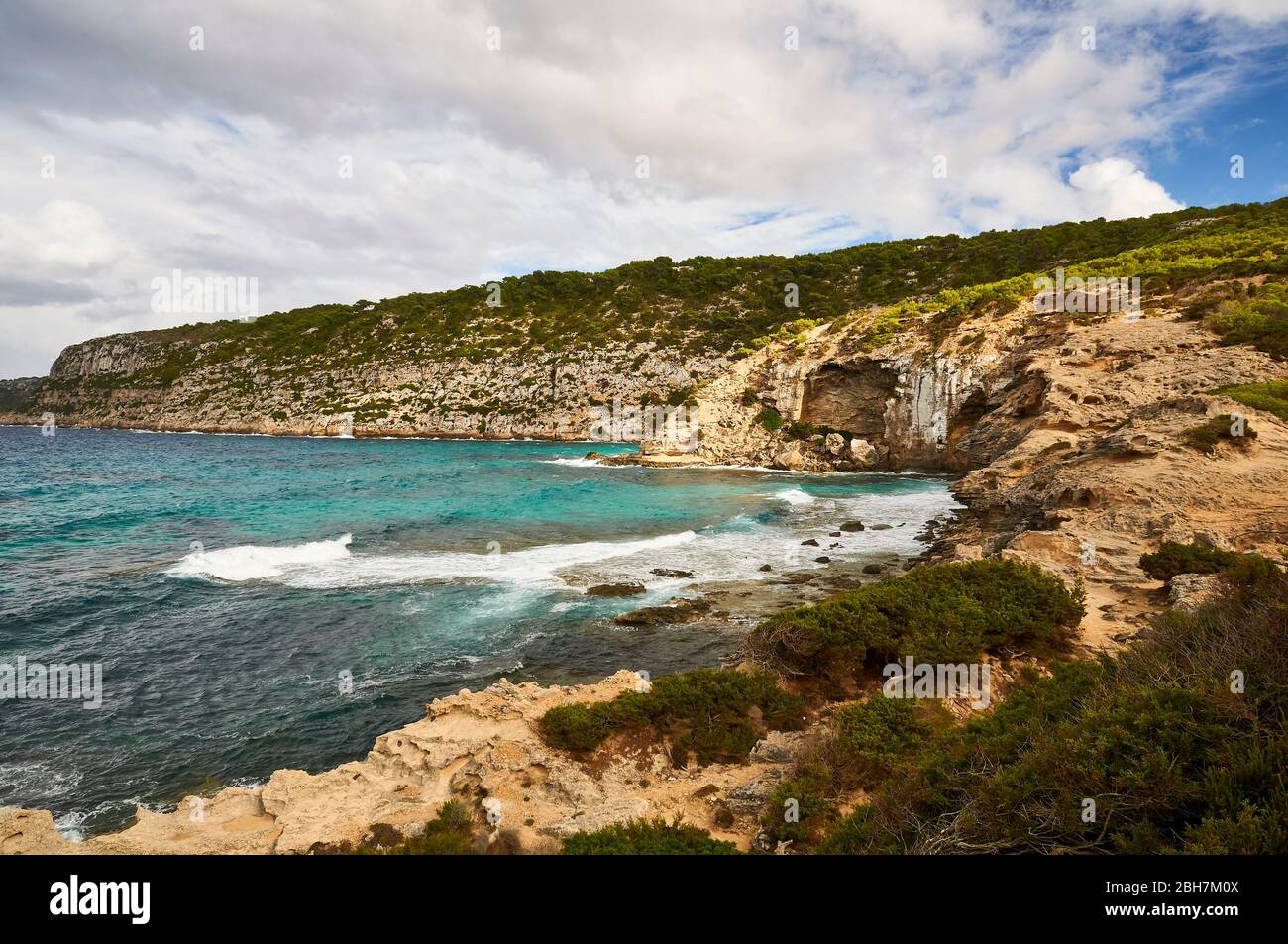 Es Carnatge coastline, Racó de Ses Pedreres marès quarry and La Mola cliffs in the background (Formentera, Balearic Islands, Mediterranean sea, Spain) Stock Photo
