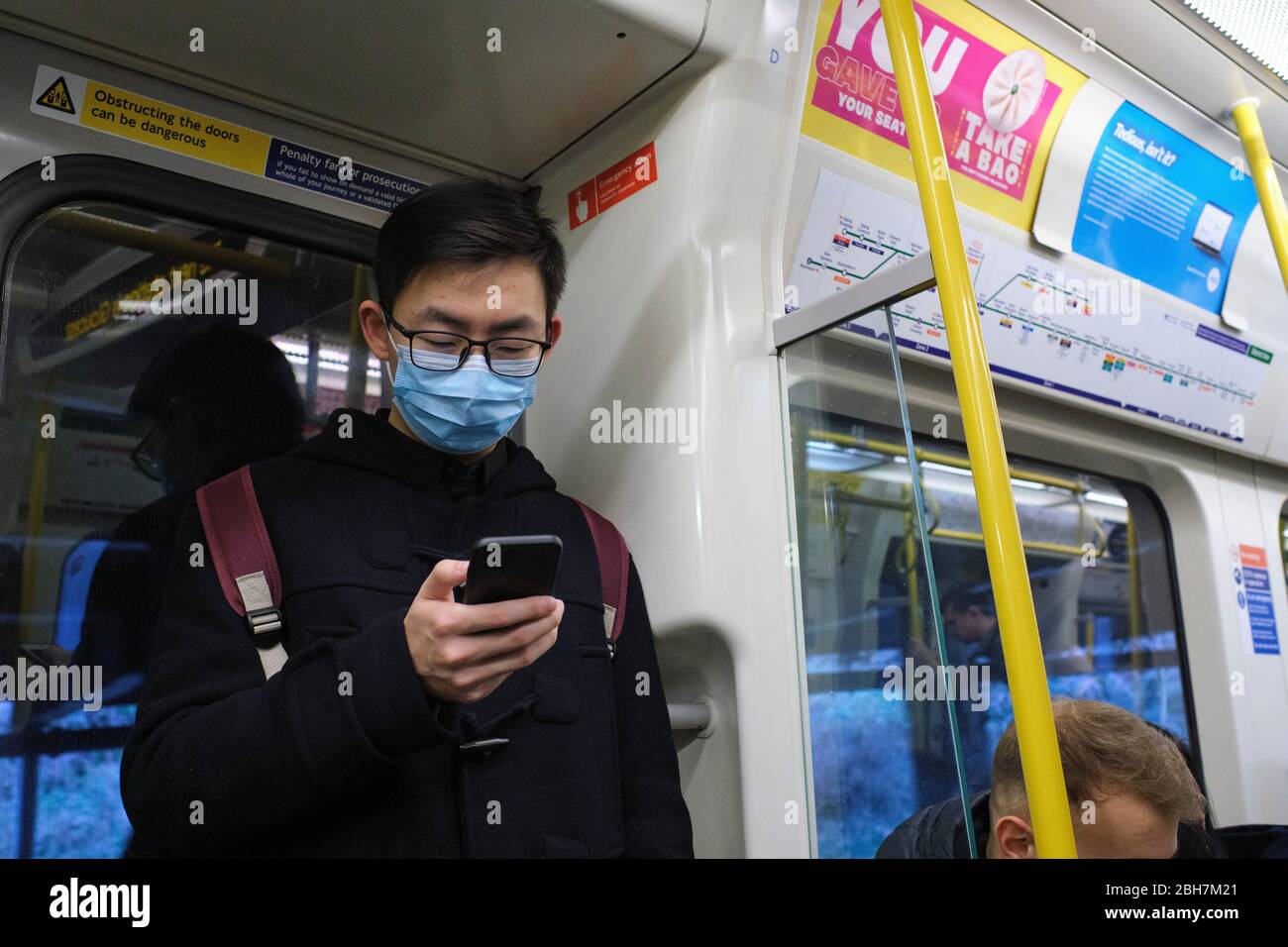 Commuters on the London Underground wearing face masks to protect