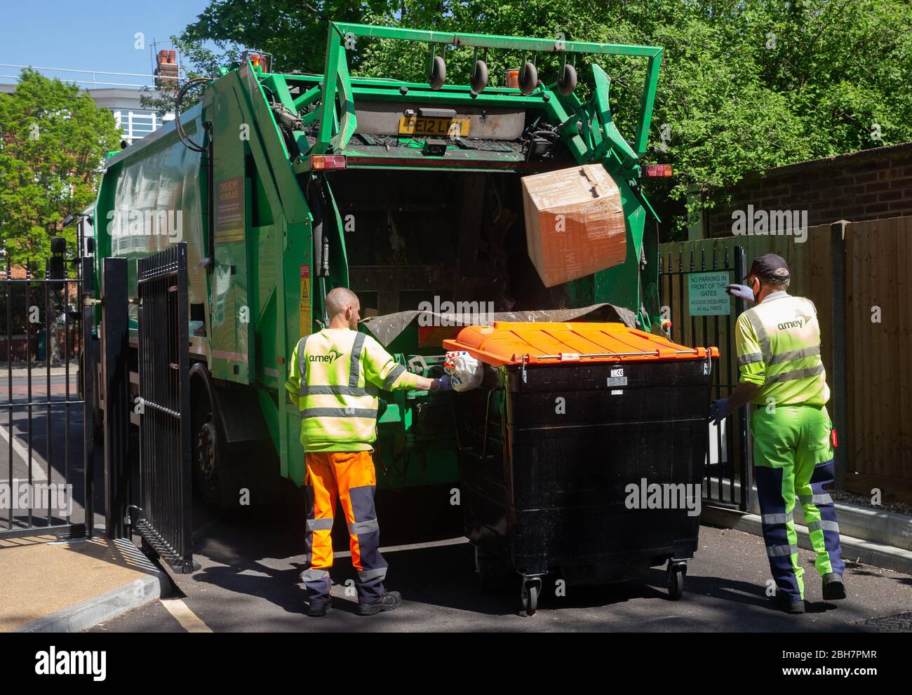 Recycling lorry and key workers collect and empty the bins during the
