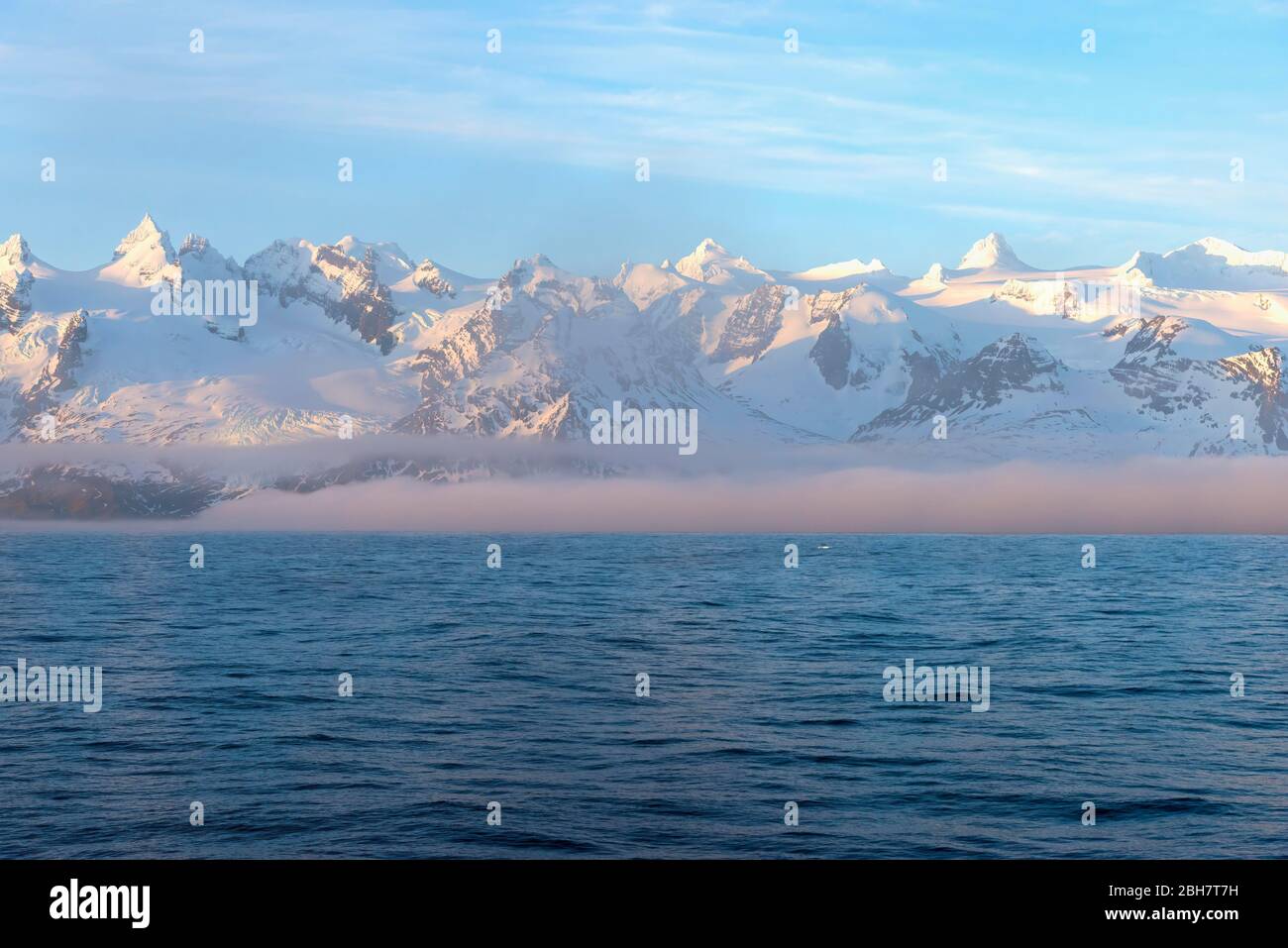 Snow-covered mountains, mountain range with snow and sea fog, West coast, South Georgia and the Sandwich Islands, Antarctica Stock Photo
