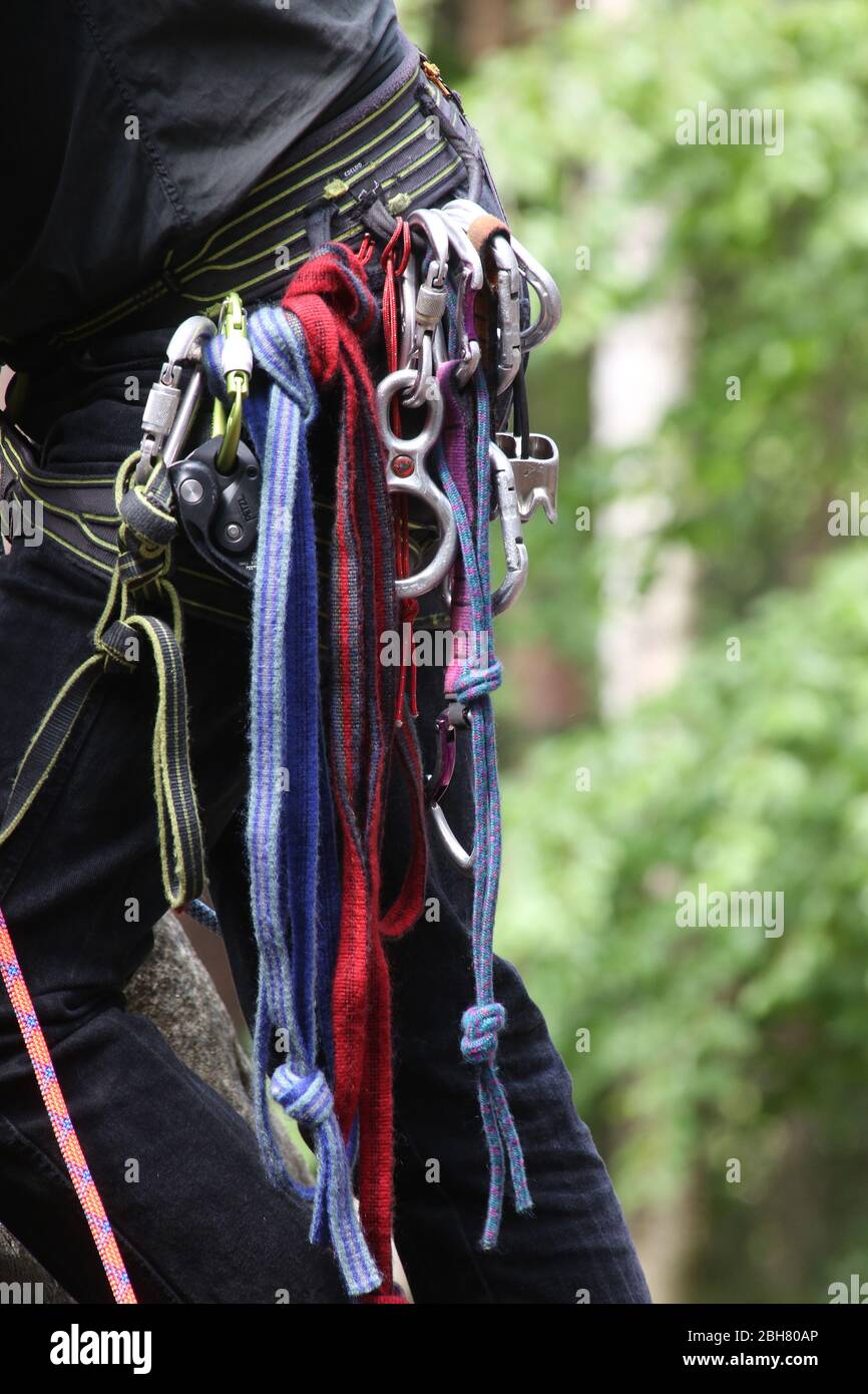 27.05.2019, Papstdorf, Saxony, Germany - Climbing ropes and safety hooks hang from trousers. 00S190527D033CAROEX.JPG [MODEL RELEASE: NOT APPLICABLE, P Stock Photo