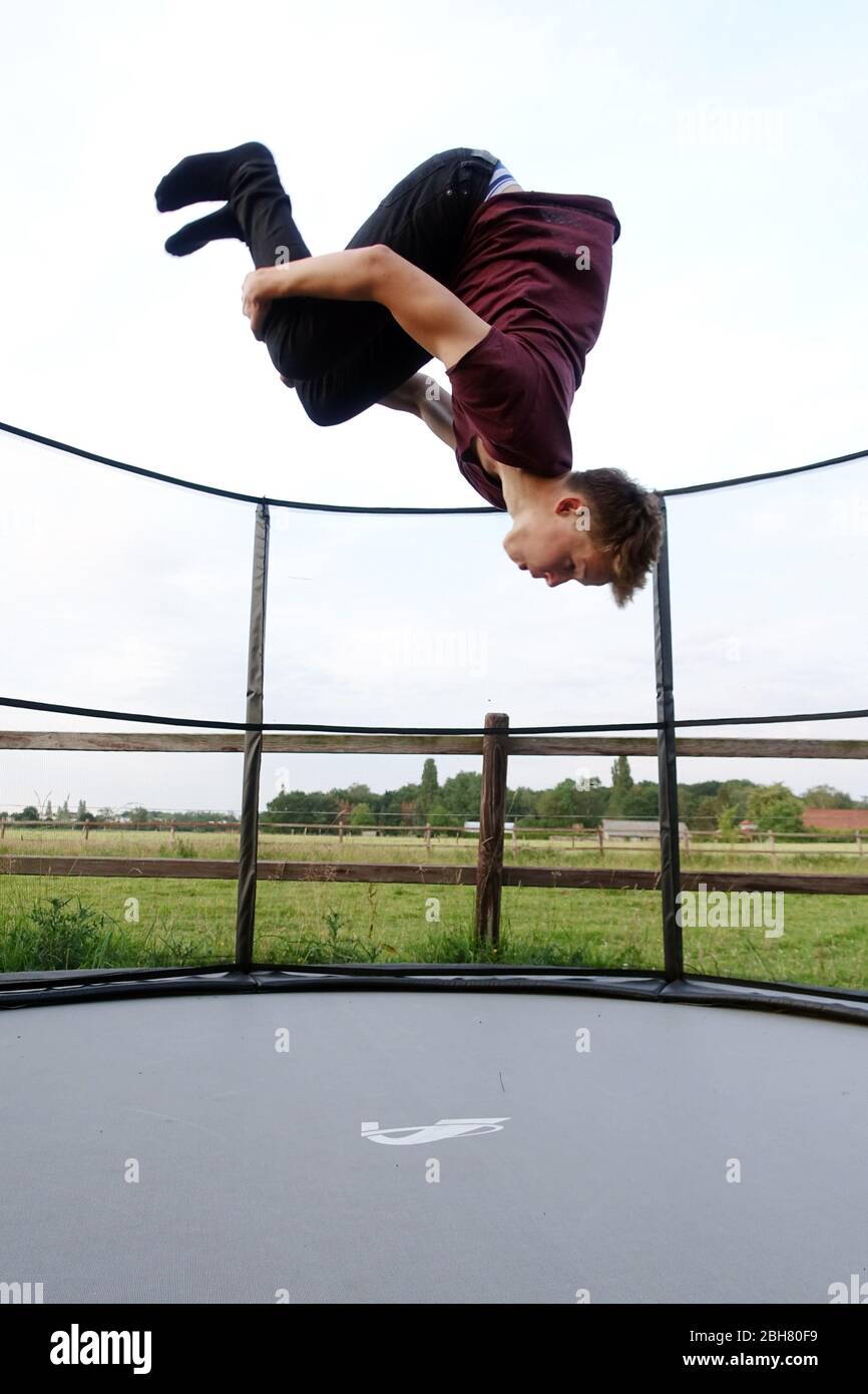 22.06.2019, Berlin, , Germany - Teenager does a somersault forward while  jumping on a trampoline. 00S190622D047CAROEX.JPG [MODEL RELEASE: YES,  PROPERT Stock Photo - Alamy