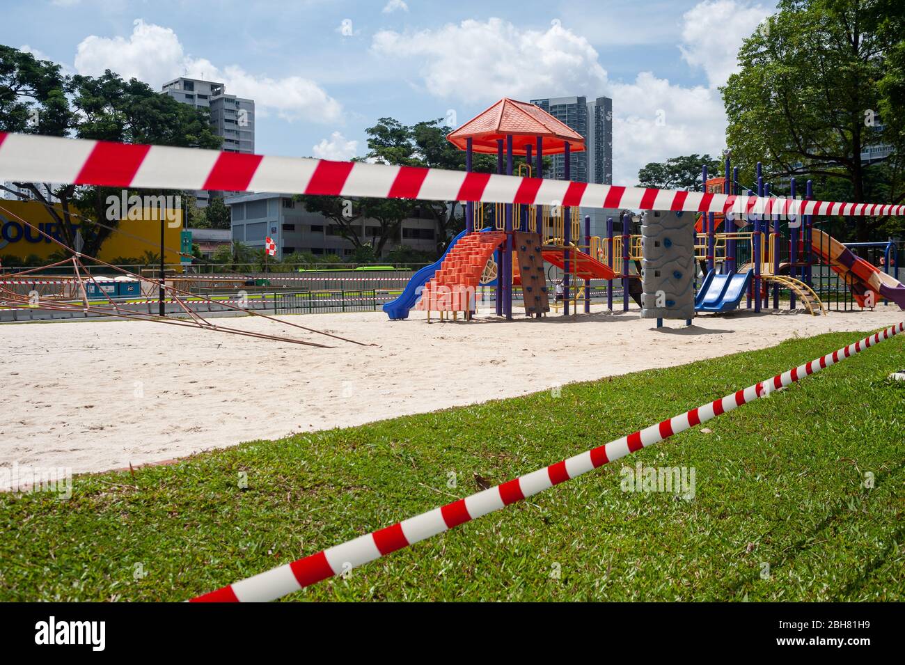 10.04.2020, Singapore, , Singapore - A playground in the district of Ang Mo Kio has been cordoned off with red and white tape. In order to further lim Stock Photo