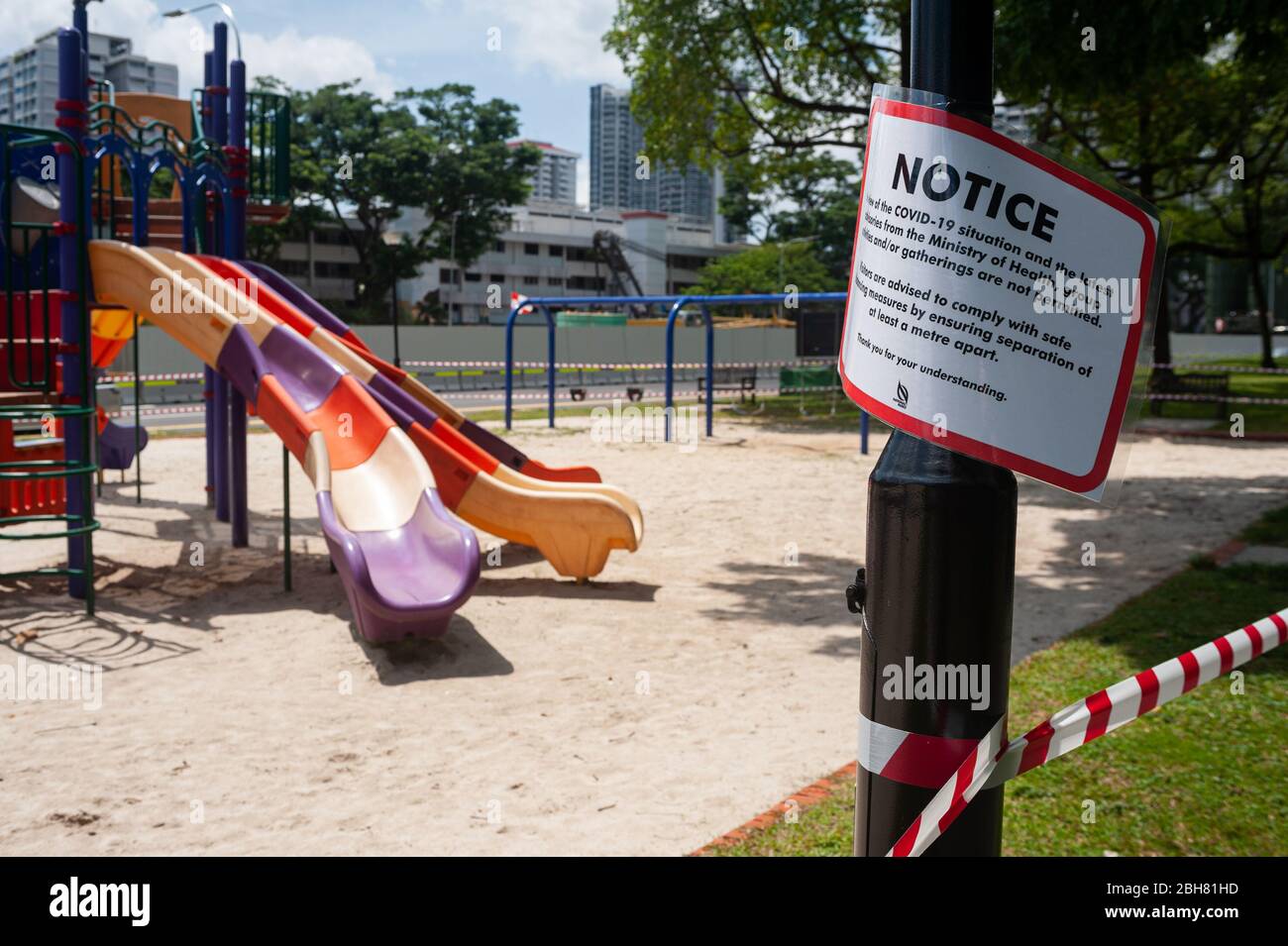 10.04.2020, Singapore, , Singapore - A playground in the district of Ang Mo Kio has been cordoned off with red and white tape. In order to further lim Stock Photo