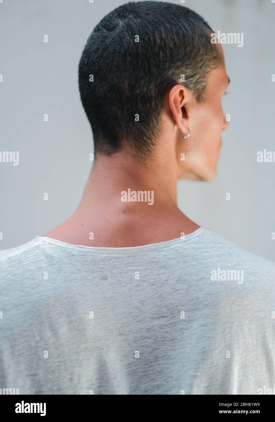 Back and neck of a caucasian young white man looking to the side with a white t shirt Stock Photo
