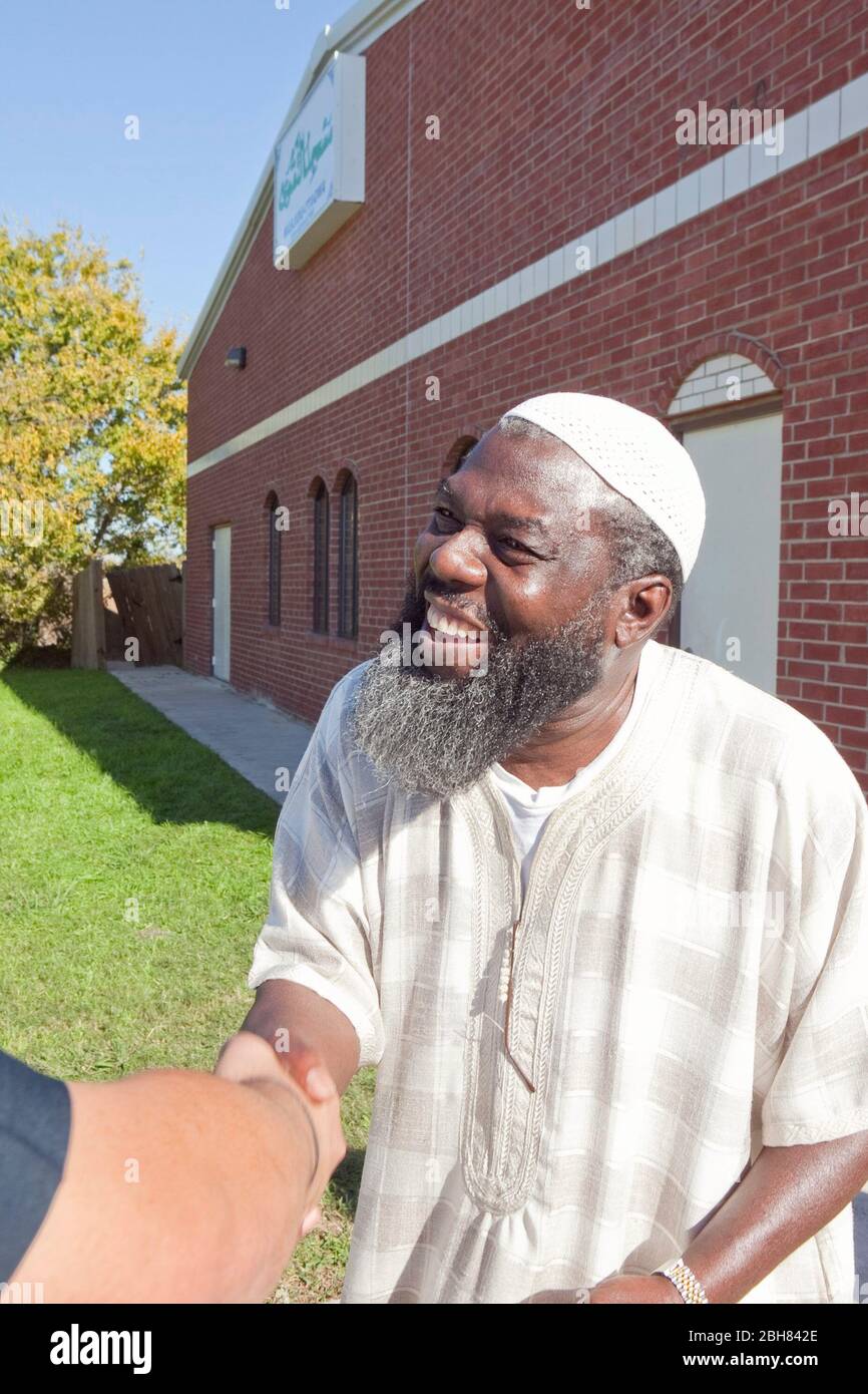 Killeen, Texas November 6, 2009: Osman Danquah, co-founder of the Islamic Community of Greater Killeen and a former Army soldier,  greets a visitor outside the mosque. Danguah was acquainted with Maj. Nidal Malik Hasan (not pictured)greet, accused of killing 13 and injuring dozens in a shooting at nearby Fort Hood, and listened to Hasan's concerns about an upcoming deployment and how it would conflict with his Muslim faith.  ©Bob Daemmrich Stock Photo