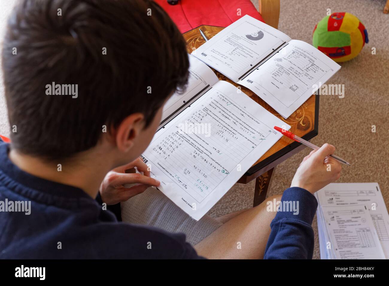 Nikolas Ioan, 15, is doing homework at his home while isolating with his family during the Covid-19 Coronavirus pandemic Stock Photo