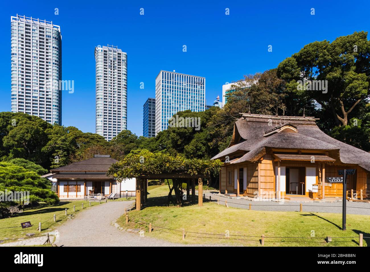 Japan, Honshu, Tokyo, Hama-rikyu Gardens and The Shiodome Area Skyline Stock Photo