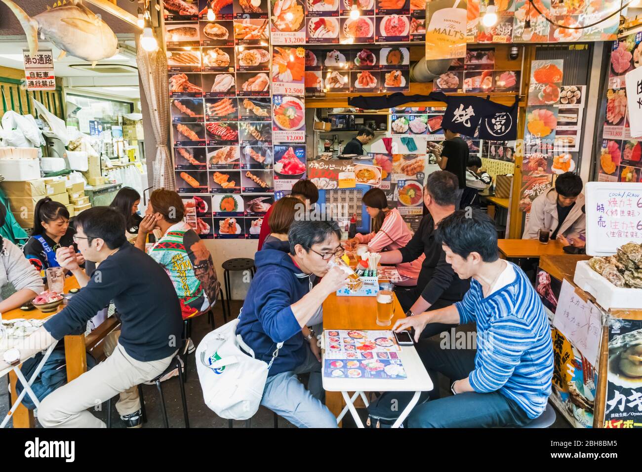 Japan, Honshu, Tokyo, Ueno, Ameyoko Shopping Street, Typical Open Air Fast Food Restaurant, People eating Stock Photo